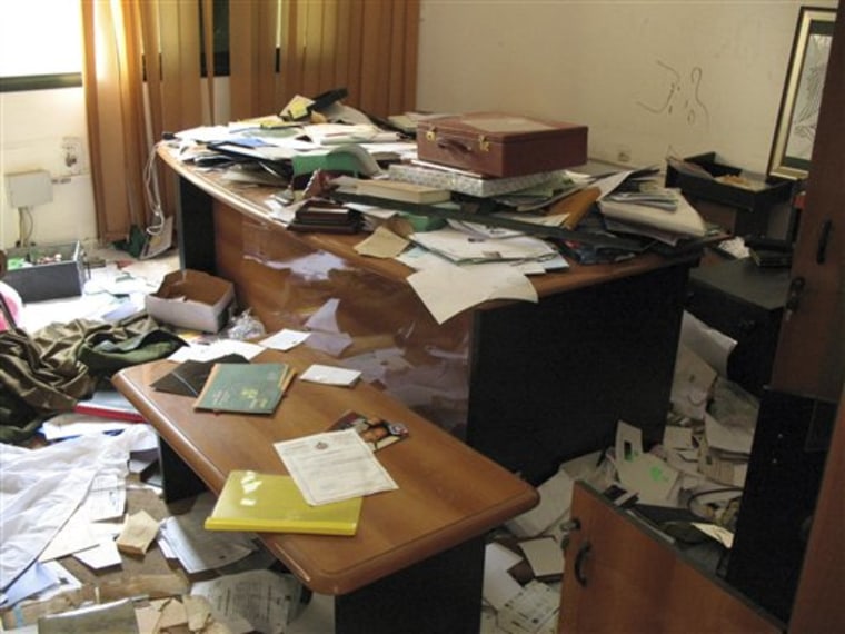 A ransacked desk in Moammar Gadhafi's intelligence headquarters in Tripoli, Libya, on Monday. Hundreds of intelligence documents seen by The Associated Press in Tripoli show how Gadhafi's authoritarian regime failed to quash an armed rebellion largely fueled by hatred of its tools of control. 